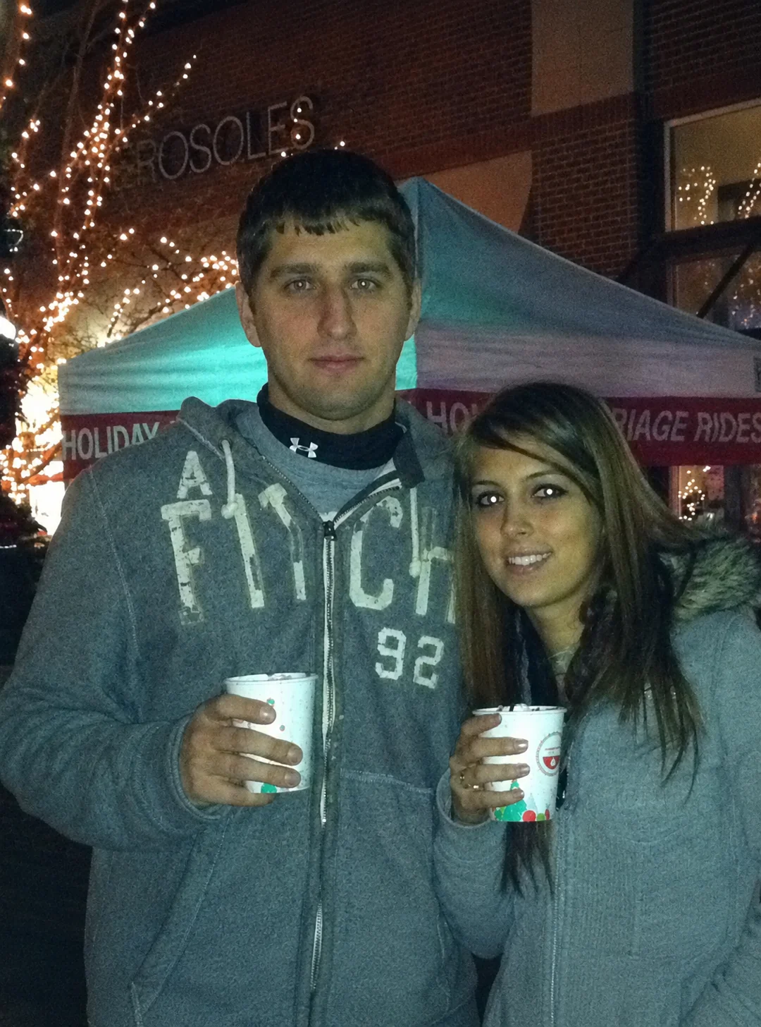 A couple sharing warm drinks during a holiday outing